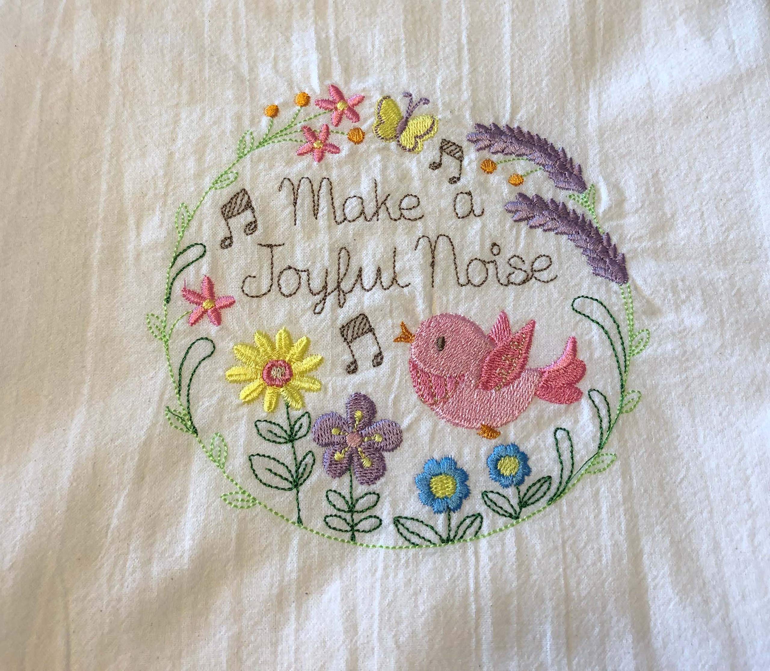 Make a Joyful Noise embroidered tea towel, bird and flowers in wreath, machine embroidery on flour sack dish towel