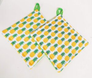 potholder set in a pineapple and green polka dot fabric print by sewuseful studios llc