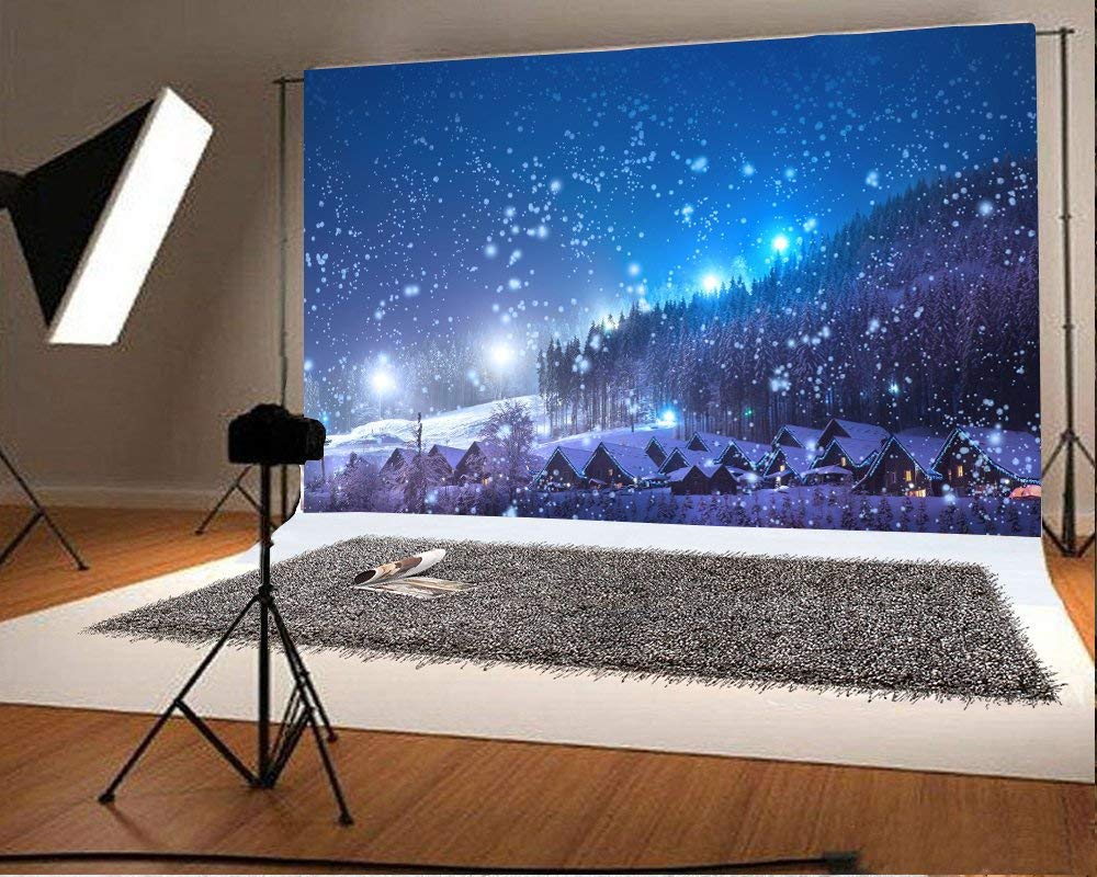 Leowefowa 7X5FT Christmas Backdrop Rustic Village Night View Forest Trees Snowing Shining Lights Blue Sky Winter Xmas Vinyl Photography Background Kids Children Adults Photo Studio Props