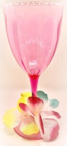 plastic pink cocktail glass with flowers on stem