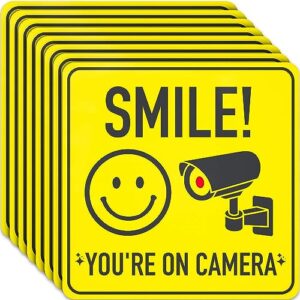 assured signs smile you're on camera signs stickers - 7 x 7 inch - 8 pack - polite video surveillance security sign to prevent trespassing on your private property - perfect for house, business, yard or driveway