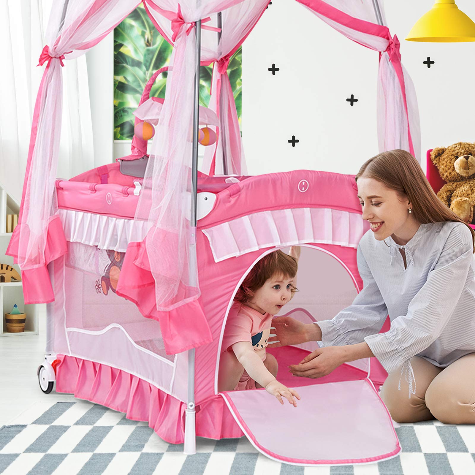 BABY JOY 4 in 1 Pack and Play with Extended Canopy, Portable Baby Playard Bedside Sleeper with Side Zipper Entrance, Wheels & Brake, Baby Girl Pink Bassinet Crib from Newborn to Toddler