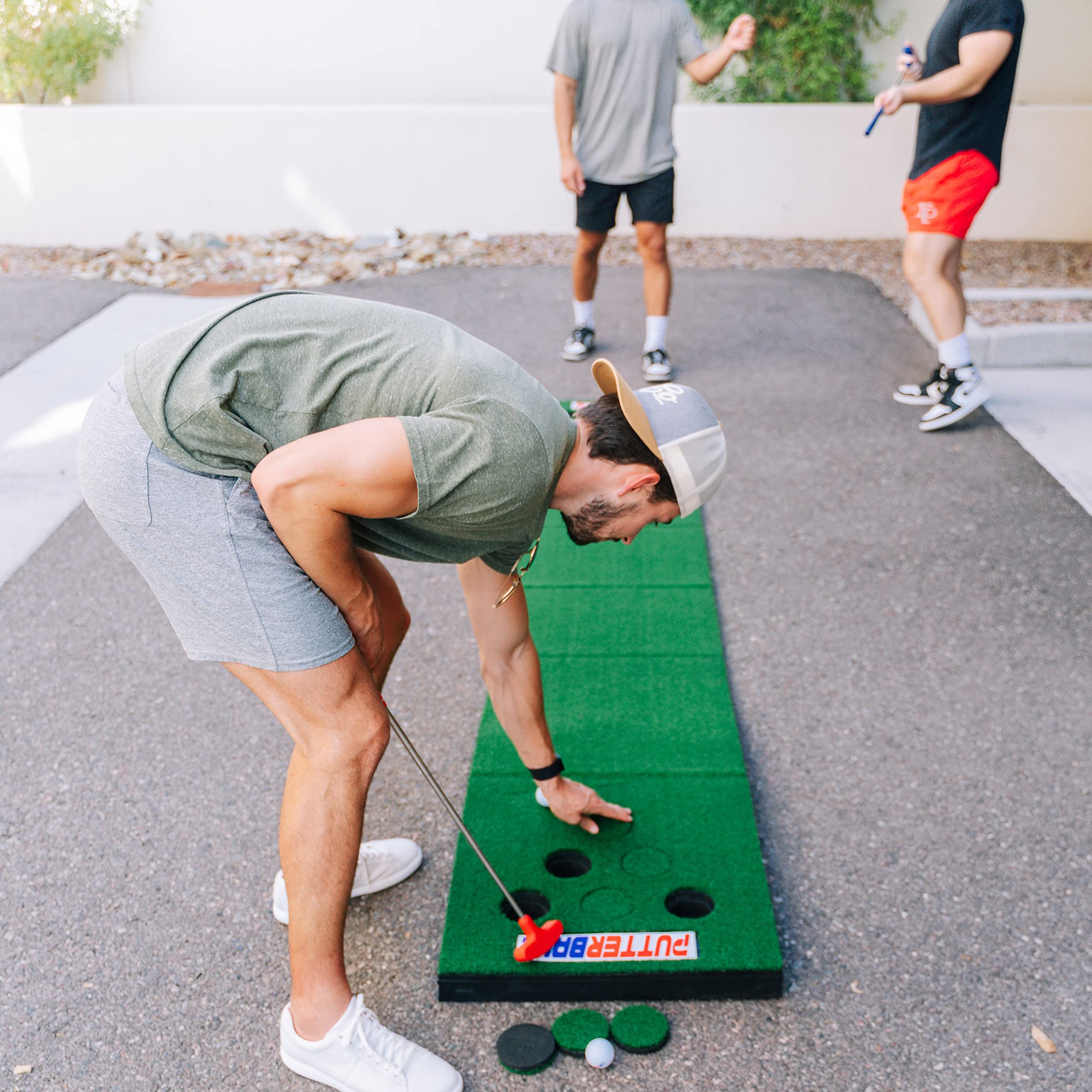 PutterBall Golf Pong Game Set The Original - Includes 2 Putters, 2 Golf Balls, Green Putting Pong Golf Mat & Golf Hole Covers - Best Backyard Party Golf Game Set