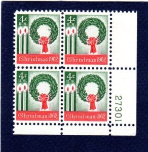 postage stamps united states. plate block #27301 of four 4 cents green & red, wreath and candles, christmas issue, stamps dated 1962, scott #1205.