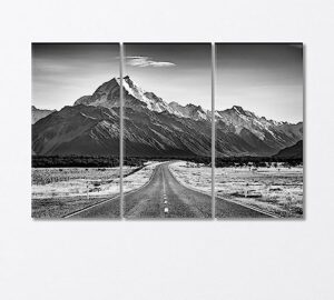 road leading towards a large snow capped mountain canvas print 3 panels / 36x24 inches