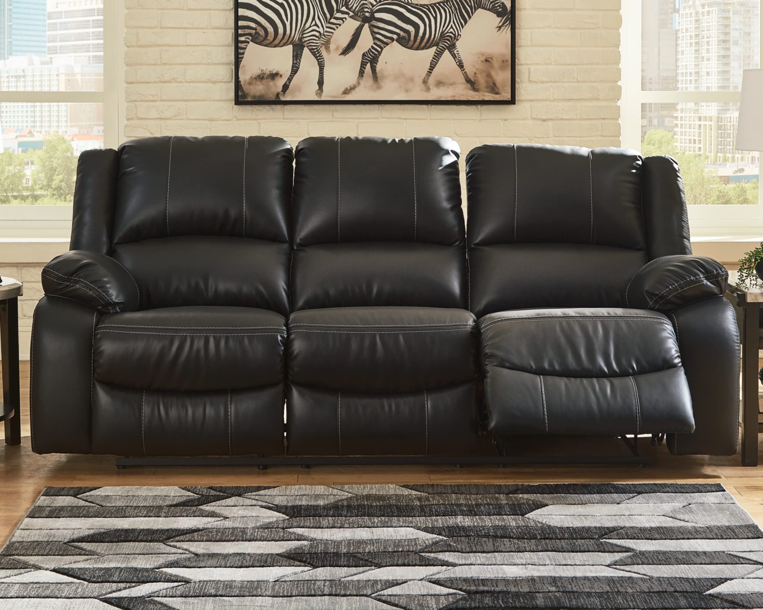 Signature Design by Ashley Calderwell Faux Leather Manual Pull-Tab Reclining Sofa, Black