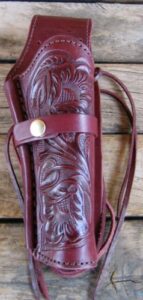 left handed burgundy tooled leather single western sass cowboy guns4us holster for 22 cal, 38 357 cal & 44 45 cal gun pistol