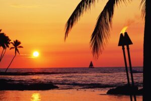 posterazzi hawaii big island kohala waiulua bay orange sunset with palm trees sailboat and tiki torches poster print, (38 x 24)