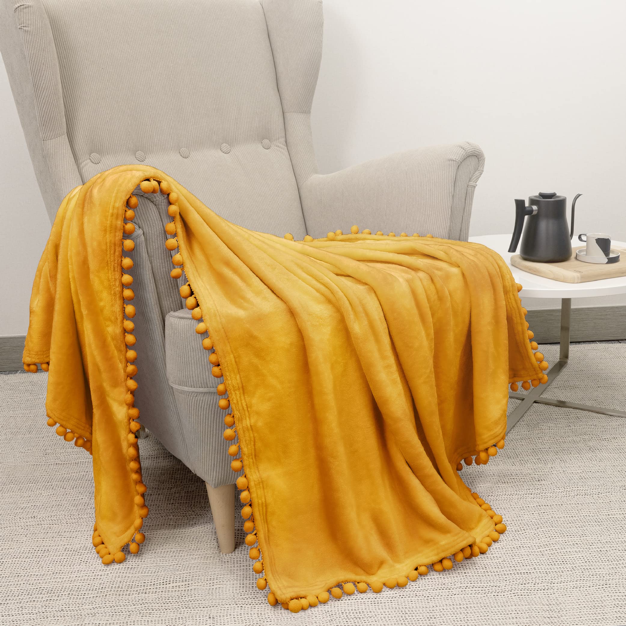 PAVILIA Mustard Yellow Throw Blanket Pom Pom for Couch, Twin Size, Soft Fleece Cozy Pompom Fringe Sofa Blanket, Decorative Home Gift Flannel Velvet, Gold Yellow, 50x60