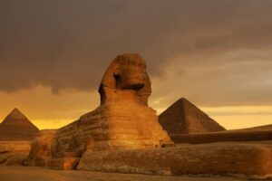 sunset on great sphinx at giza and pyramid complex giza necropolis photo photograph ancient egypt ruins monuments desert landscape cool wall art print poster 18x12