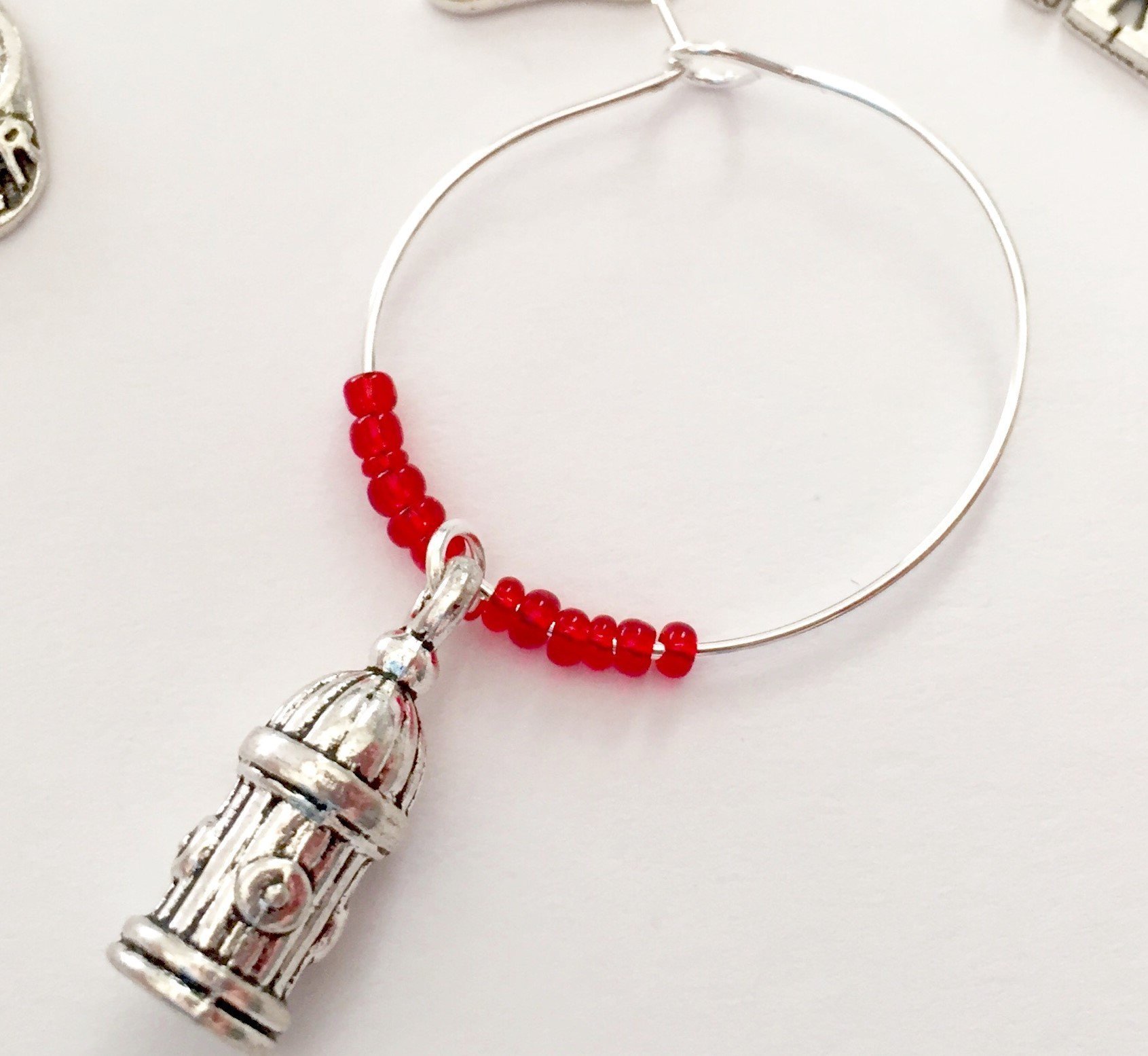 Firefighter themed Wine Charms, wine gift for fire fighter. Includes Helmet and Axe, Fire Dept Emblem, Flame, Fire Extinguisher, and Hydrant. Set of 5. RED BEADS.