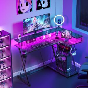 SEVEN WARRIOR L Shaped Gaming Desk with LED Lights & Power Outlets, 47” Reversible Corner Desk with Storage Shelf, Computer Desk with Monitor Stand, Gaming Table with Cup Holder, with Hooks, Black