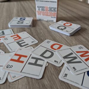 PARTY CRASH GAMES Presents: THREE WORDS OR LESS - A Simple, Yet Challenging Little Word Game; Designed for 2-6 Players 13+ Who are A Clever Wordsmith... 3 WORDS OR LESS