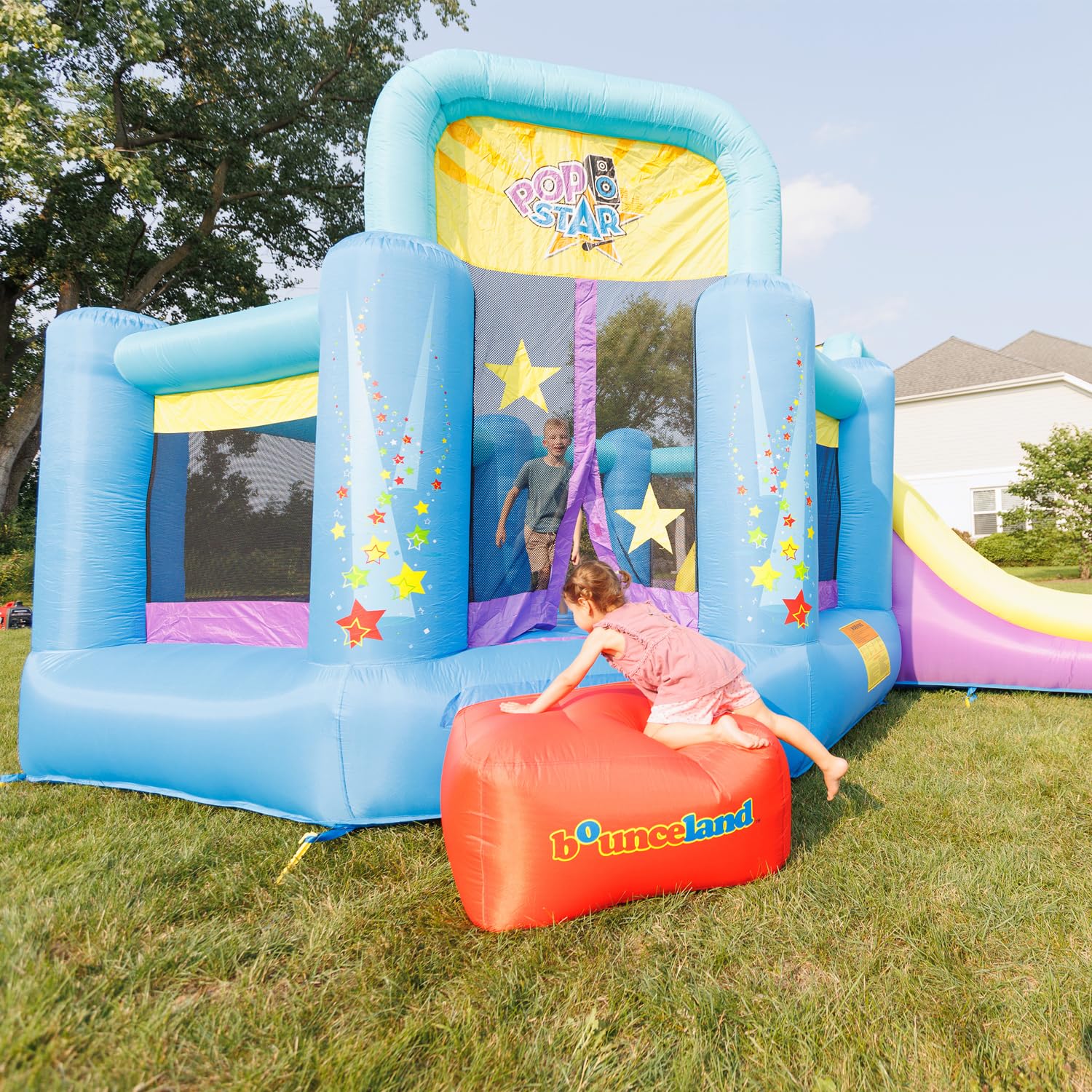 Bounceland Pop Star Inflatable Bounce House Bouncer, Large Bouncing Area with Long Slide, Climbing Wall, Basketball Hoop, UL 1HP Blower Included, 15 ft x 13 ft x 8.3 ft H, Pop Star Kids Party Theme