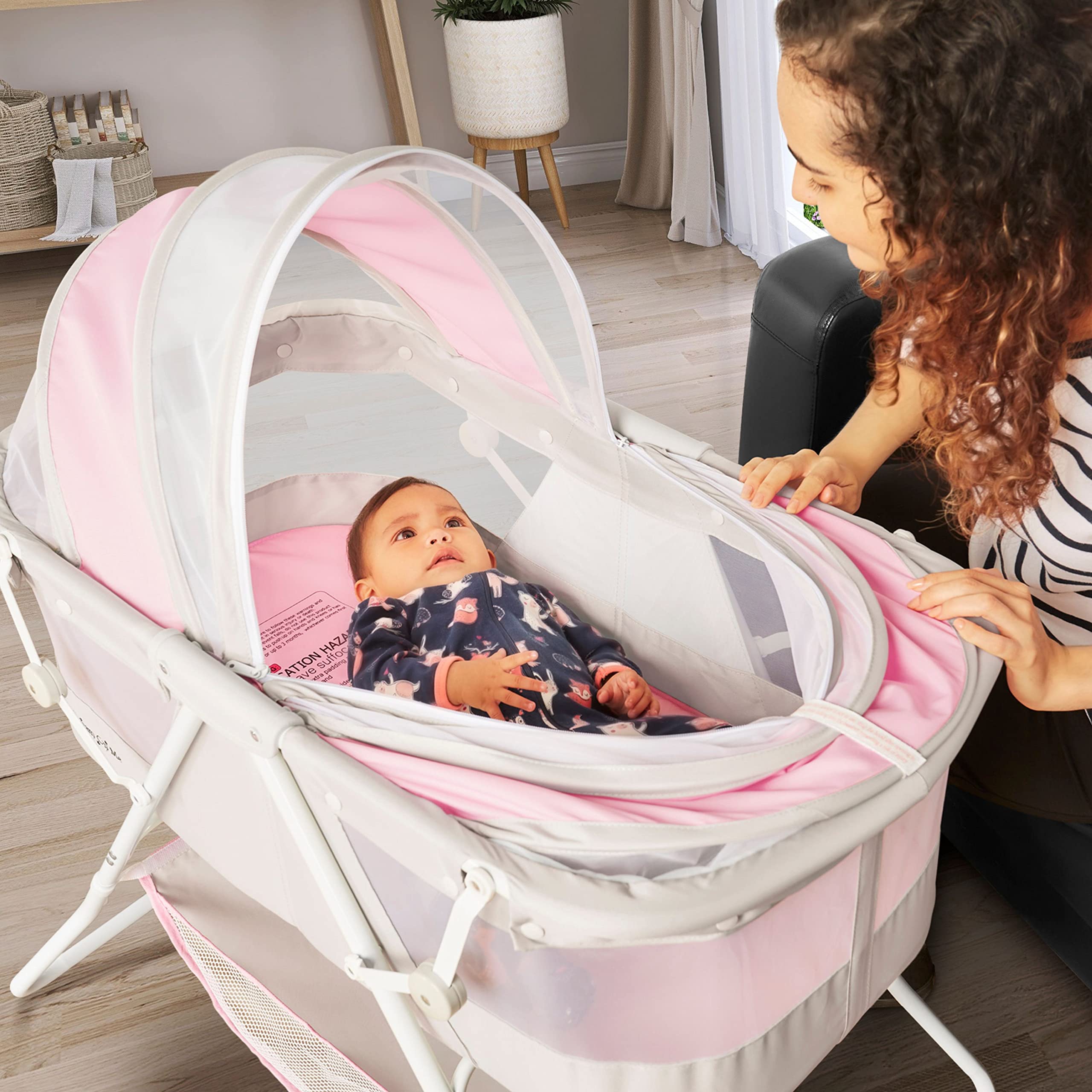 Karley Baby Bassinet in Grey and Pink, Lightweight Portable, Quick Fold and Easy to Carry , Adjustable Double Canopy, Indoor and Outdoor with Large Storage Basket.