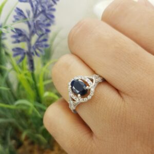 Dazzlingrock Collection 7x5mm Oval Blue Sapphire & Round White Diamond Split Shank Halo Engagement Ring for Women (0.25 ctw, Color I-J, Clarity I2-I3) in 10K White Gold, Size 7.5