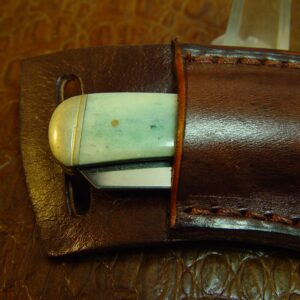 Custom Right-hand Cross Draw Trapper Style Folding Knife Sheath. Made Out of 10 Ounce Buffalo Hide Leather. Dyed Light Brown Sheath Only Knife Not Included.