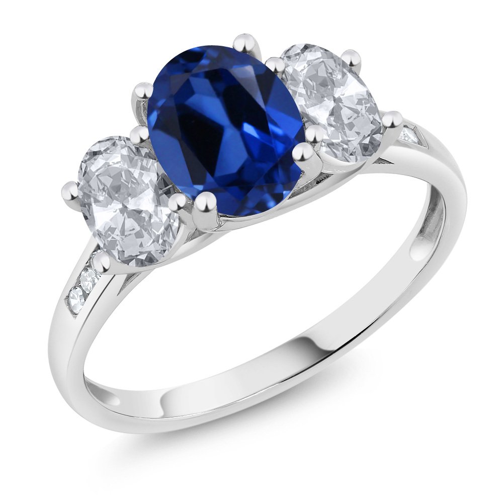 Gem Stone King 10K White Gold Blue Created Sapphire White Topaz and White Diamond Oval 3-Stone Engagement Ring For Women (2.60 Cttw, Gemstone September Birthstone, Available In Size 5, 6, 7, 8, 9)