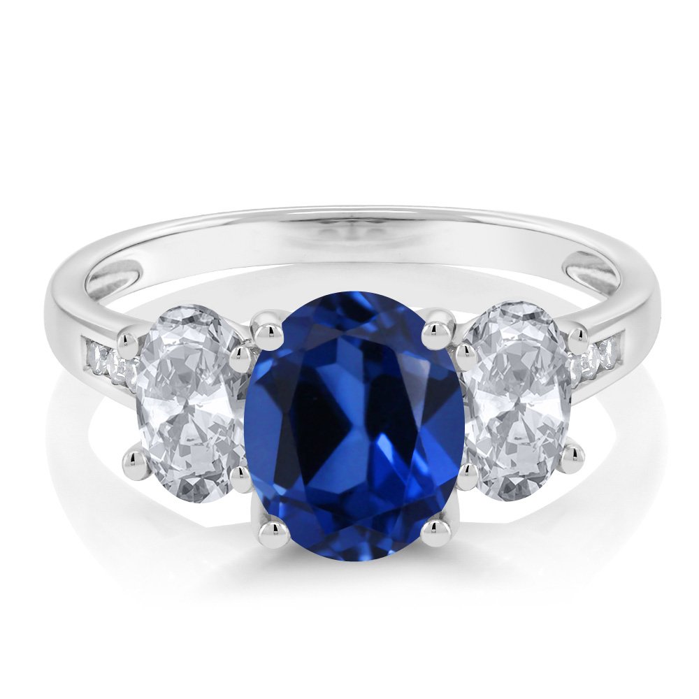 Gem Stone King 10K White Gold Blue Created Sapphire White Topaz and White Diamond Oval 3-Stone Engagement Ring For Women (2.60 Cttw, Gemstone September Birthstone, Available In Size 5, 6, 7, 8, 9)