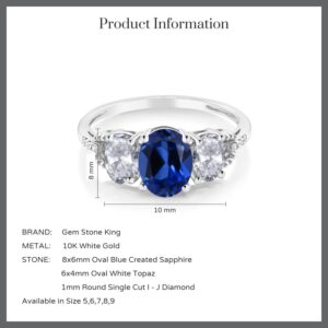 Gem Stone King 10K White Gold Blue Created Sapphire White Topaz and Diamond Accent 3 Stone Engagement Ring For Women (2.65 Cttw) (Size 8)