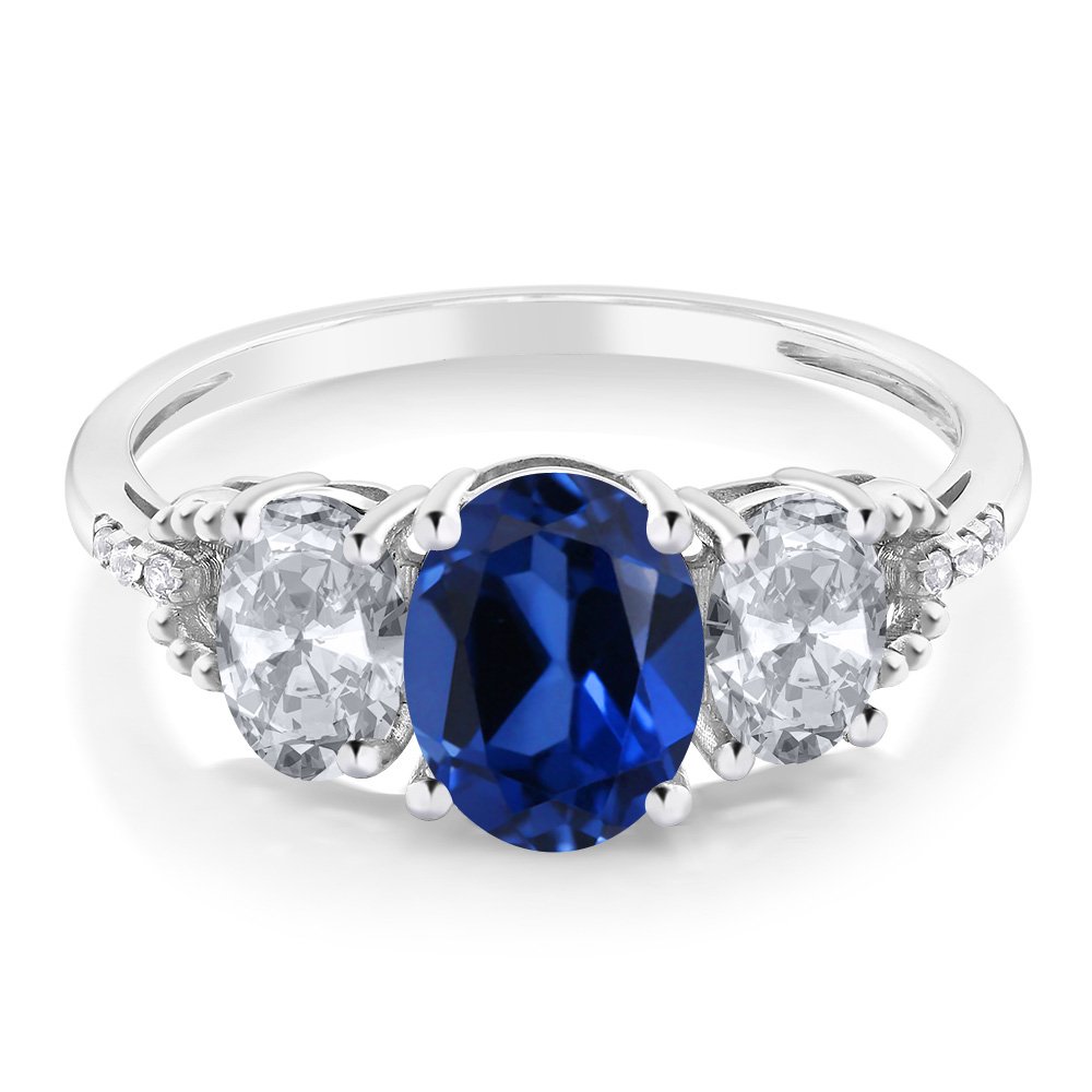 Gem Stone King 10K White Gold Blue Created Sapphire White Topaz and Diamond Accent 3 Stone Engagement Ring For Women (2.65 Cttw) (Size 8)