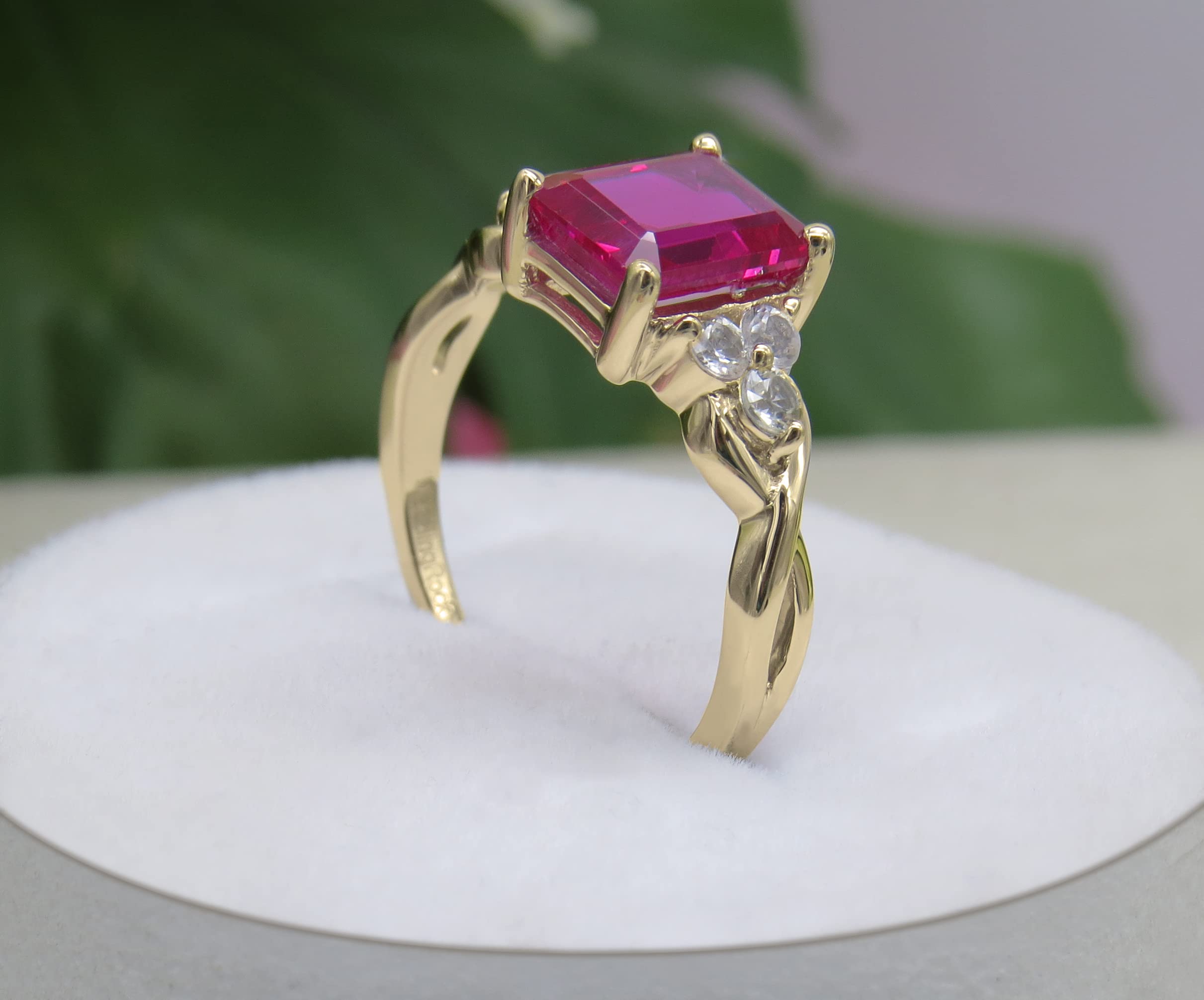 Dazzlingrock Collection 8x6mm Emerald Shape Center Lab Created Ruby & 2.2mm Round White Sapphire on Side Crisscross Shank Engagement Ring for Her in 10K Yellow Gold Size 7