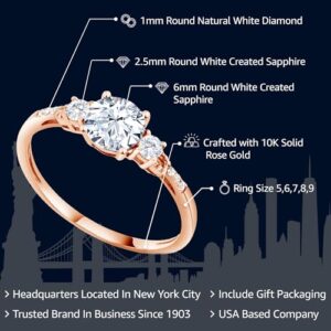 Gem Stone King 10K Rose Gold 6MM Round Gemstone Birthstone White Created Sapphire and White Diamond Accent 3-Stone Engagement Ring | Three-Stone Wedding Anniversary Promise Ring For Women