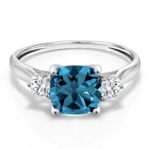 gem stone king 10k white gold london blue topaz & white moissanite 3 stone engagement ring for women | 2.11 cttw | cushion 7mm | gemstone birthstone (size 9)