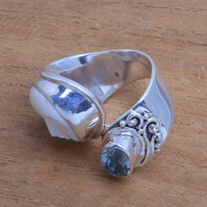 NOVICA Artisan Handmade Blue Topaz Cocktail Ring Bone Face from Bali Sterling Silver Indonesia Birthstone Gemstone [ring Front 0.6 in L x 0.6 in W x 0.3 in H Band Width 7 mm W] ' Sparkling Face'