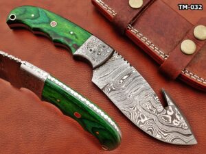 9.5" hand forged damascus steel gut hook skinning knife, green wood scale with damascus bolster, full tang blade twist pattern drop point blade, cow hide leather sheath