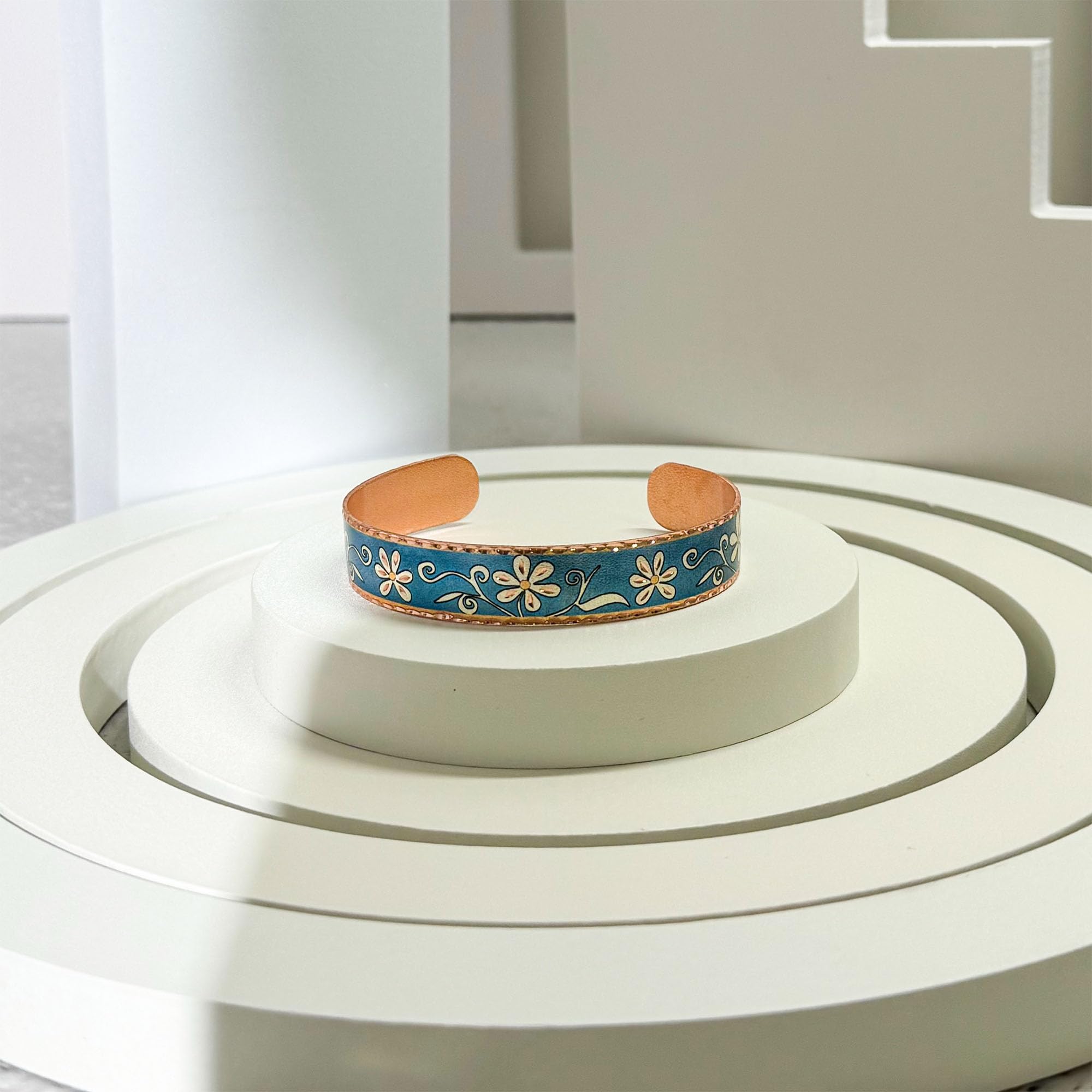 Women's Daisy Flower Bracelets feature a beautiful daisy flower on a blue copper cuff with an open-ended flower cuff design. These copper bracelets are adjustable for a perfect fit—BNF-06.