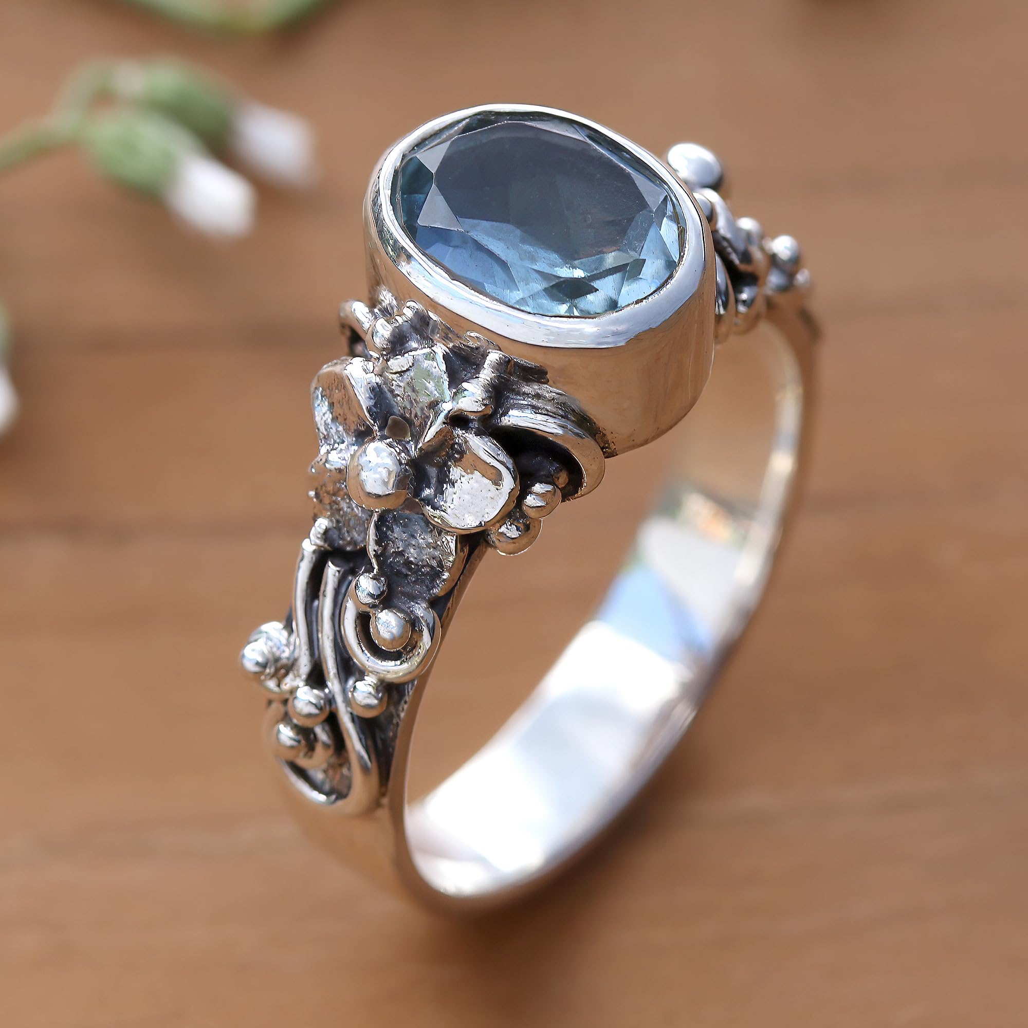 NOVICA Artisan Handmade Blue Topaz Single Stone Ring Oval Cut Silver with Floral Design Sterling Cocktail Indonesia Serenity Birthstone [crownbezel 0.4 in L x 0.3 in W x 0.3 in H Band Width 4 mm W]