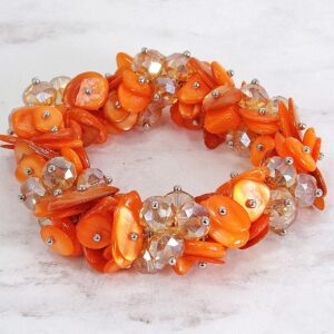 Calisa Designs Woman's orange shell and glass beaded stretch bracelet with silver beads, Designed with clusters of orange shell and orange facet cut glass beads.