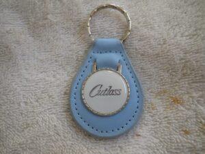 1960's 1970's era cutlass emblem logo leather keychain - light blue