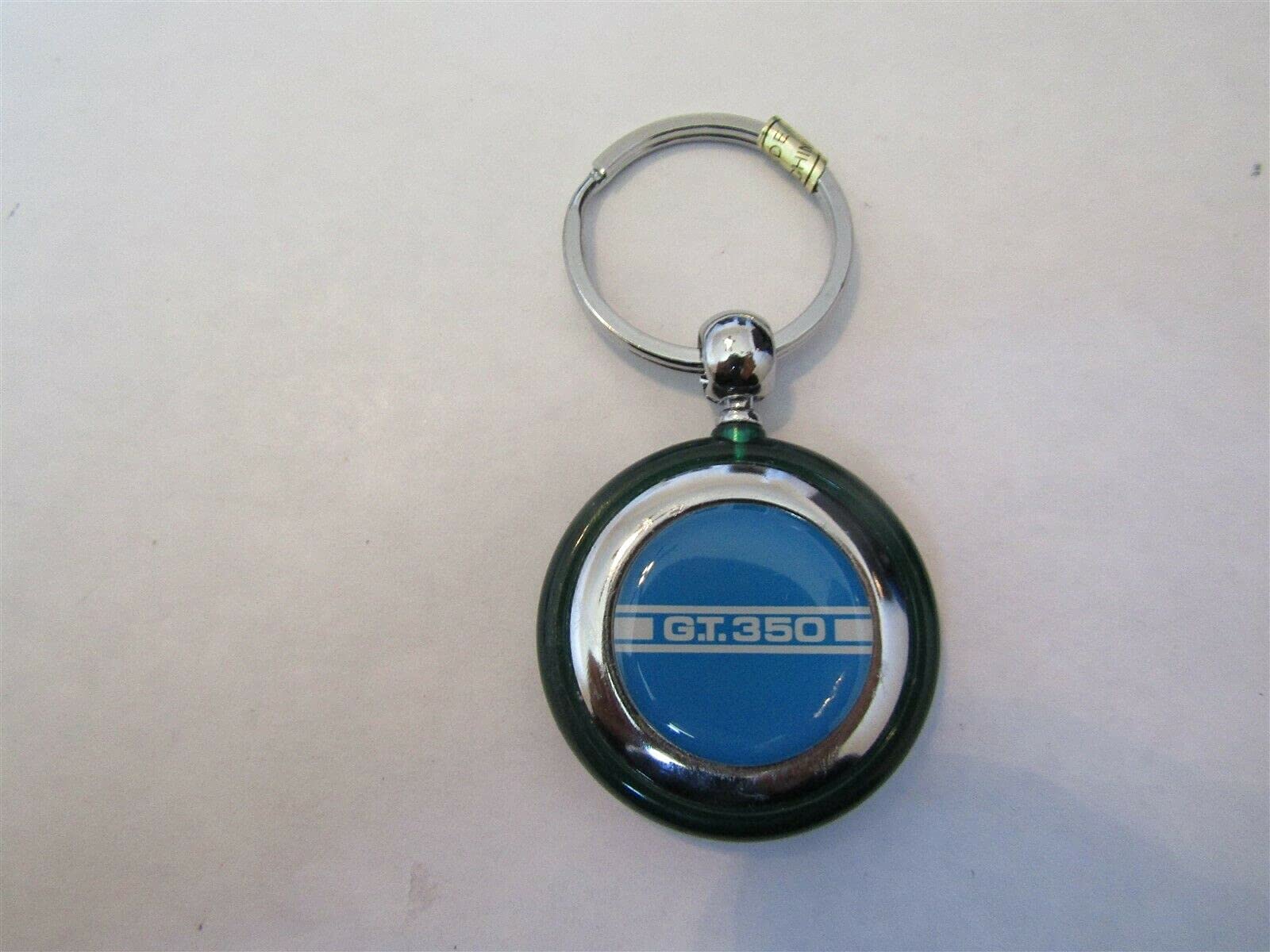 1965 1966 1967 1968 1969 1970 SHELBY GT-350 WHITE STRIPE ON BLUE ROUND PLASTIC KEYCHAIN - GREEN