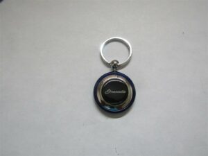 1975 1976 1977 1978 1979 1980 1981 1982 granada script logo round plastic keychain - blue