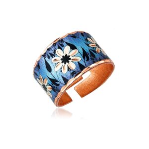 artisan handcrafted copper cuff rings - wide cuff rings feature a daisy flower with a black leave textured leaf on a blue backdrop