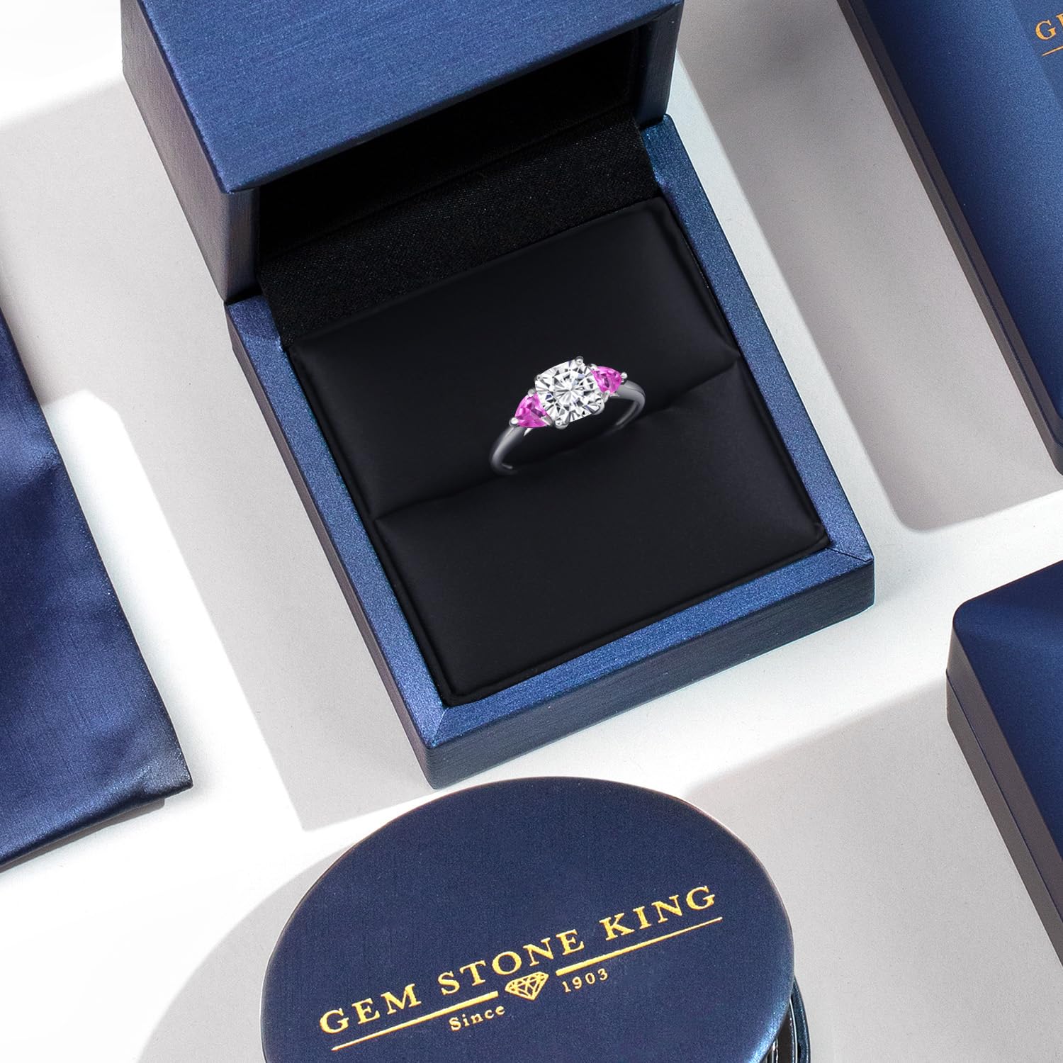 Gem Stone King 10K White Gold White Moissanite and Pink Created Sapphire 3-Stone Engagement Ring For Women (2.30 Cttw, 7MM Cushion and 4MM Trillion, Available In Size 5, 6, 7, 8, 9)