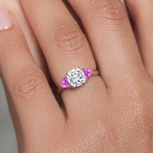 Gem Stone King 10K White Gold White Moissanite and Pink Created Sapphire 3-Stone Engagement Ring For Women (2.30 Cttw, 7MM Cushion and 4MM Trillion, Available In Size 5, 6, 7, 8, 9)