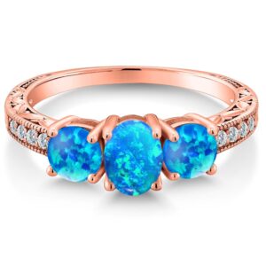 Gem Stone King 18K Rose Gold Plated Silver Oval Cabochon Blue Simulated Opal Engagement Ring For Women (1.75 Cttw, Available In Size 5, 6, 7, 8, 9)