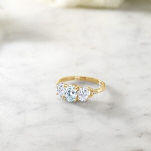 Gem Stone King 10K Yellow Gold Sky Blue Aquamarine White Moissanite and Diamond Accent 3-Stone Women Engagement Ring (1.77 Cttw, Available In Size 5, 6, 7, 8, 9)