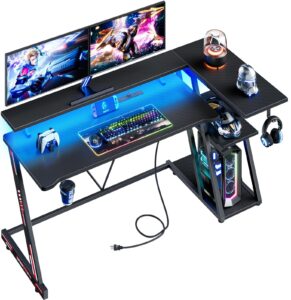 korfile reversible gaming desk with power outlet & led lights, corner computer desk with 3 tiers storage shelves, home office desk with monitor stand for small space, 47 inch carbon fiber black