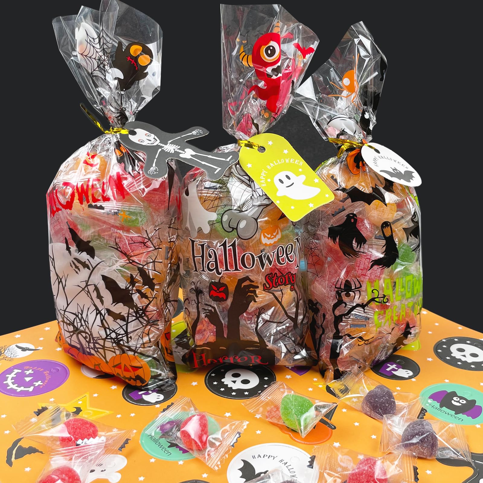 GOMANCHE Halloween Cellophane Treat Bags, 100 pcs Clear Halloween Goodie Bags with 100pcs Twists Ties, 4 Styles Halloween Cellophane Candy Bags with Gift Tag for Kids Halloween Party Supplies