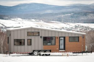 tiny rv mobile house with downstairs bedroom, loft, full kitchen & bathroom - family-friendly design with upraised living area, cedar/steel exterior, double-pitched roof - perfect for full-time living