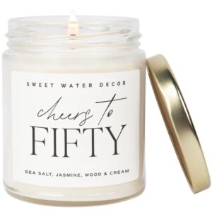 sweet water decor cheers to fifty candle - sea salt, jasmine, wood, and cream scented candle for home - 9oz clear jar with 40 hour burn time, made in usa - 50th anniversary and birthday gifts