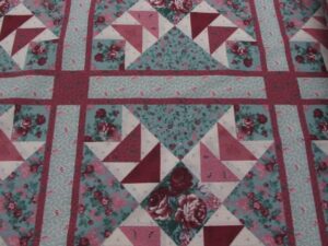 90'' wide cheater quilt top rose burgandy. fabric is sold by the yard and cut to order. for example, order of 1 yard (qty=1) is 90" x 36". order of 3 yards (qty=3) is 90" x 108".