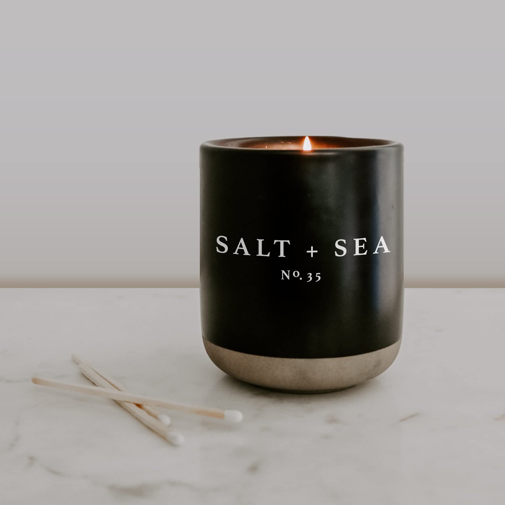 Sweet Water Decor Salt and Sea Soy Candle | Sea Salt, Citrus, Musk and Amber Scented Soy Candles for Home | 12oz Black Stoneware Jar, 60+ Hour Burn Time, Made in the USA